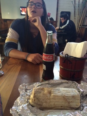 The paneer tikka masala burrito and a Coke make for a wonderful meal combination.