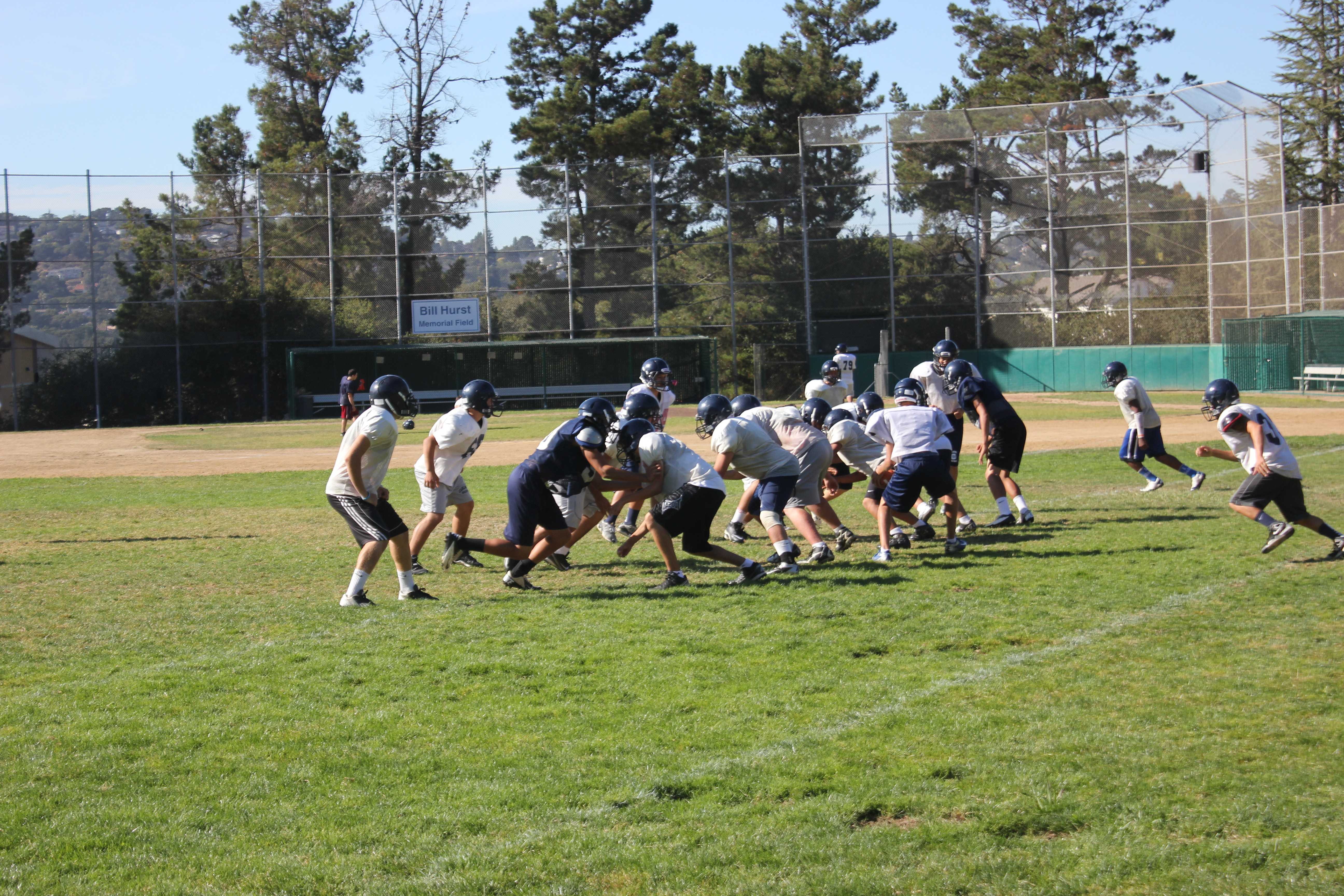 The Junior Varsity football team practices on the baseball fields.
