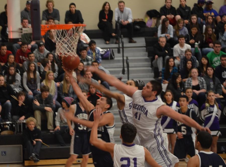 Carlmonts Hector Prado goes up for a layup against Sequoias Julian Bertero