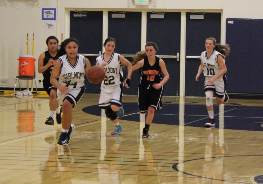 Sophomore Vianka Adamovitch rushes back to her basket after stealing the ball from Woodside High School.