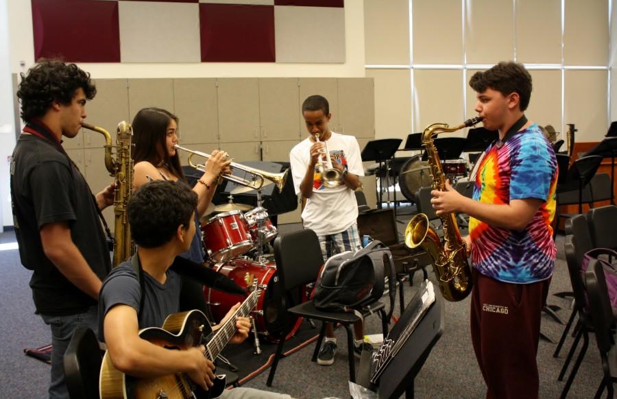 Jazz Ensemble members swap instruments and jam together after class.