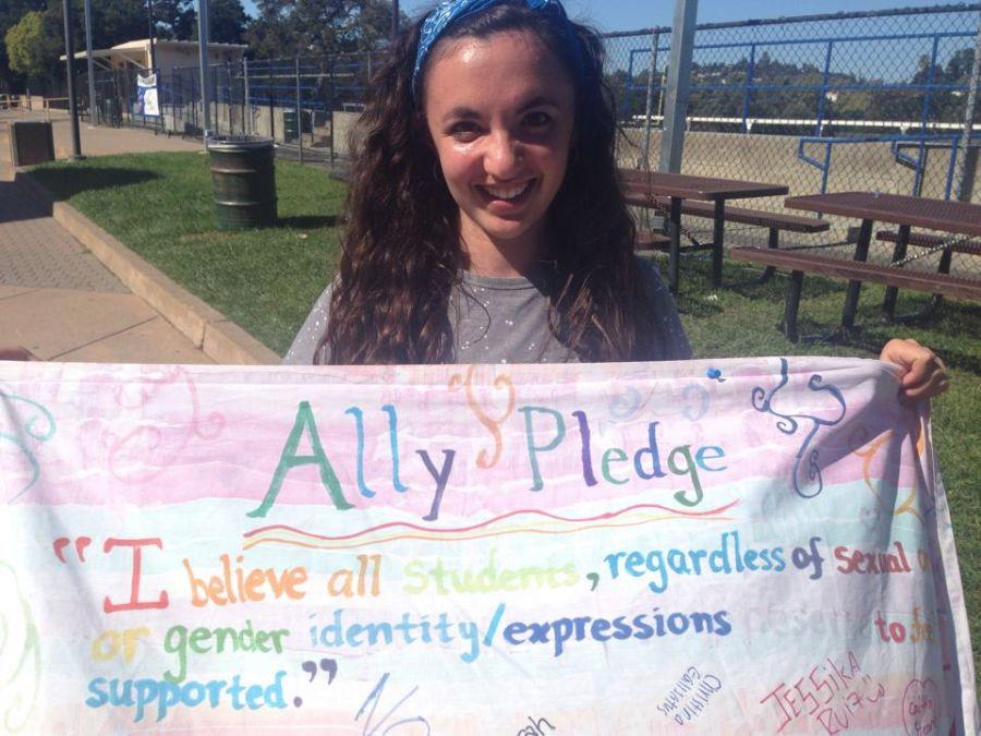 President Segal holds the banner from last years Ally Week. 