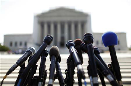 News microphones wait to capture reactions from U.S. Supreme Court rulings outside the court building in Washington, June 25, 2013.
