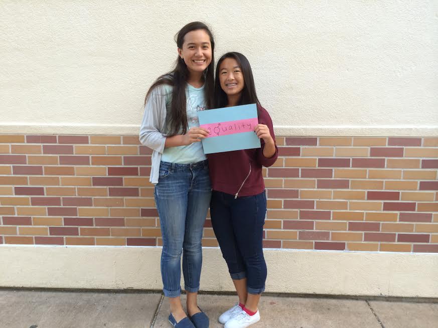 Feminist+Club+members%2C+Sophomores+Evelyn+Lawrence+and+Sydney+Pon%2C+hold+up+the+equality+sign.