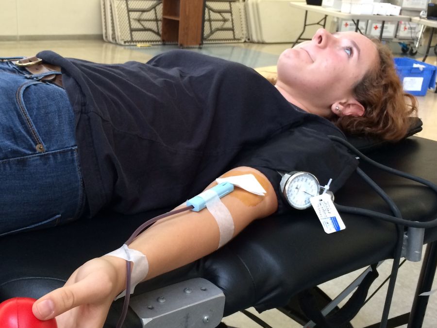 Zoe Wildman braces herself while getting blood drawn during Carlmonts blood drive.