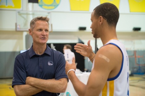 Head coach Steve Kerr talks strategy with superstar Stephen Curry