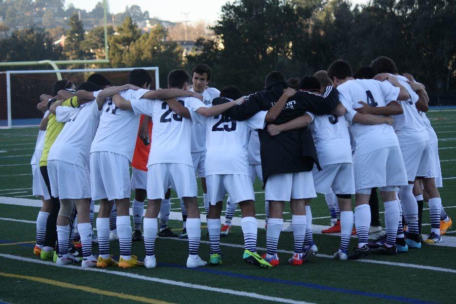 The team huddles before the game, giving each other encouragement. We came out nervous because for a lot of us it was our first varsity game. Its easy to cope with the nerves because we all love each other. Its a brotherhood, said sophomore Paul Bastaki.