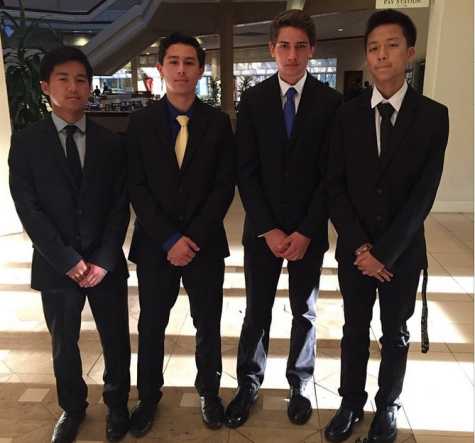Liam Jocson, Spencer Enriquez, River Manochio, and Ethan Wong pose at the DECA LACE conference in their business attire.