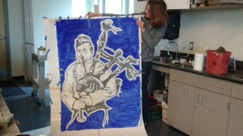 Emily Kelvin displays the stencil of Carlmonts mascot that the art club has been working  on.