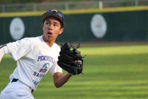 Outfielder Josef Gonzalez, a freshman, checks his shoulder while running back to catch a fly ball.