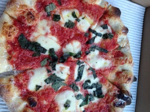 Howie's delicious Margherita pizza topped with fresh basil.