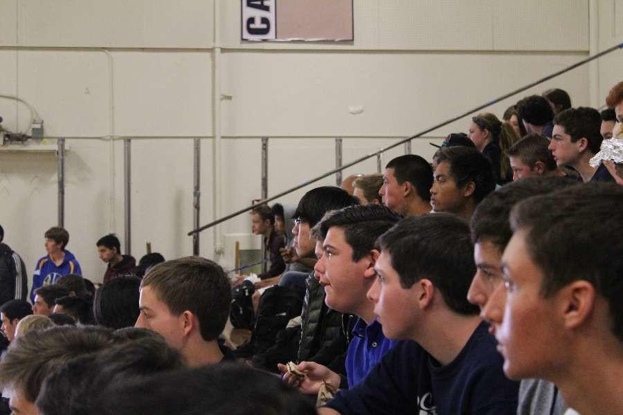 Students intently watch the senior versus teachers game.