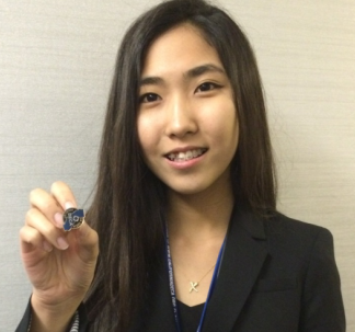 Sophomore Bo Yoon Lee shows off her top eight finalist pin after getting off stage. 