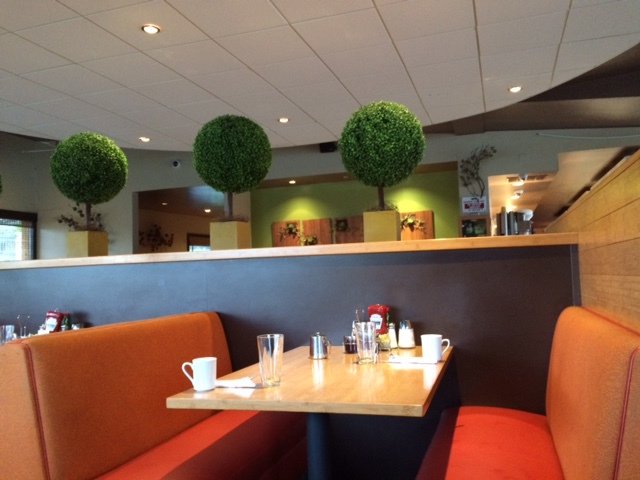 Stacks is decorated with cute plants on the walls and between the booths.