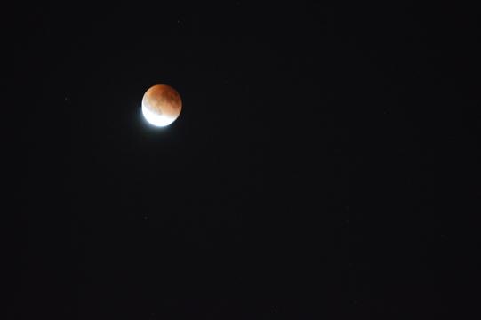 The blood moon glows for some of its last few moments late Sunday night.