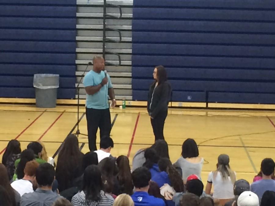 Guest speaker Keith Hawkins asks Senior Taylor Murray about her relationship with her family during the Welcome Back Assembly.