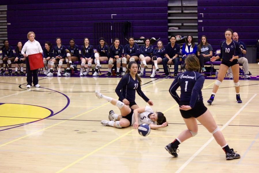 Seniors Erin Alonso and Elena Mateus go in for a painful dive during a Carlmont volleyball game.