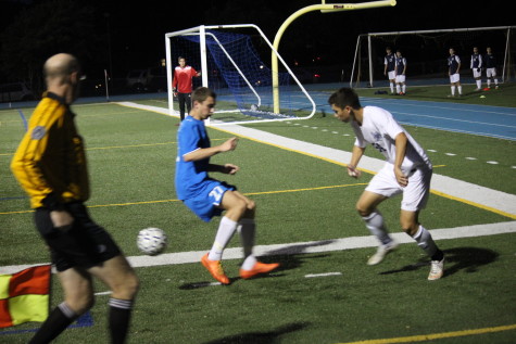 Sophomore Noah Sanchez trying to play the ball out of the corner and past the defender.