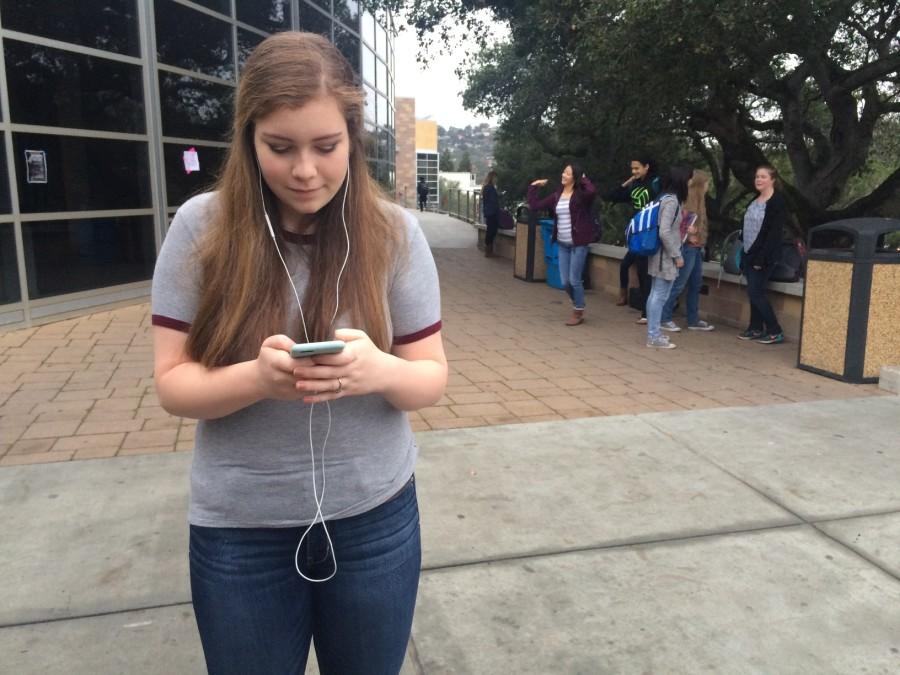 Apple Music user Emma Armstrong streams unlimited music from iTunes from the convenience of her iPhone.