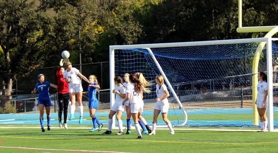 Center defender senior Isabelle de Wood goes up for a header to clear out the Panthers corner kick.
