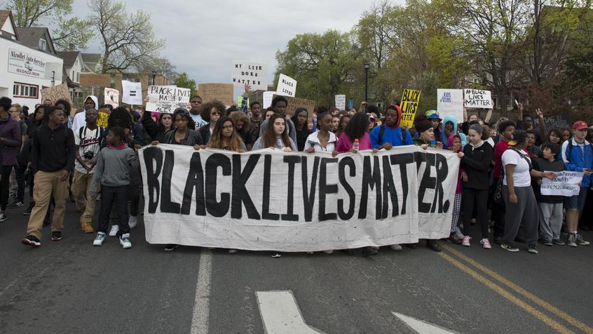 Black Lives Matter supporters march in protest to raise awareness for their cause.