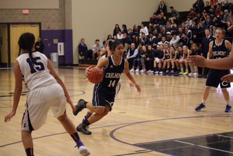Junior Alexa Bayangos dribbles the ball down the middle of the key.
