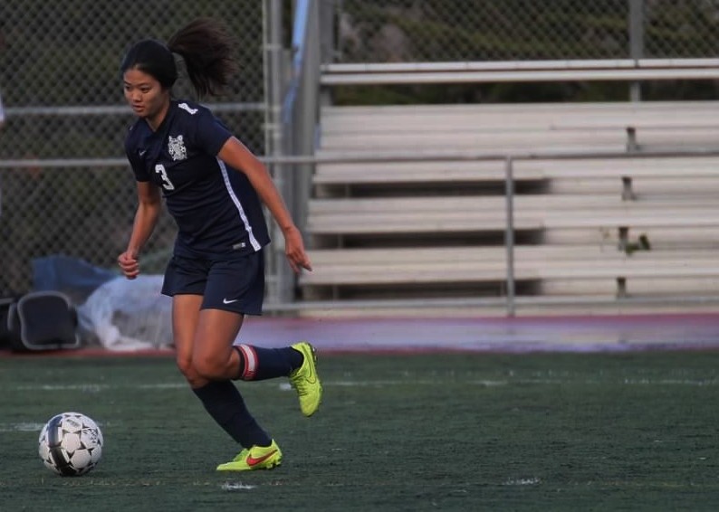 Team captain senior Kayla Fong dribbles downfield to press for another attempt on goal.