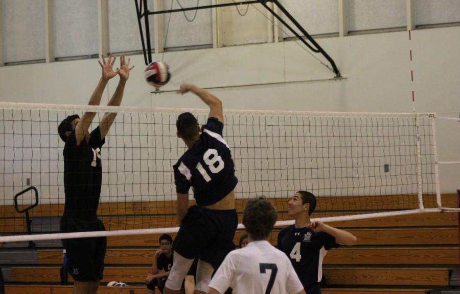 Senior Malcolm McClellan (18) spikes the ball, earning a point for the Scots.