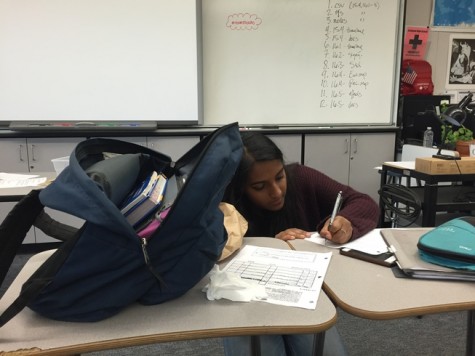 Student Rhea Subramanian rushes to finish her work as she settles back into the routine of school.