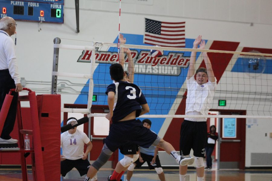Junior Chris Ding smashes the ball over the net, earning a point for the Scots.