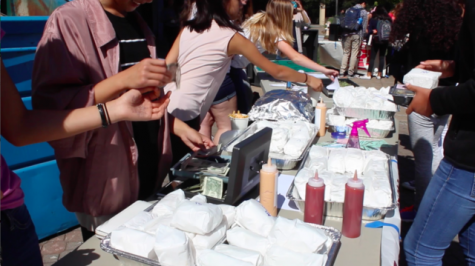 Students sell food to promote their clubs. 