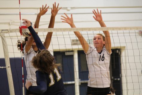 Juniors Sophie Srivastava and Emma Vanoncini block the Tigers strong hit.