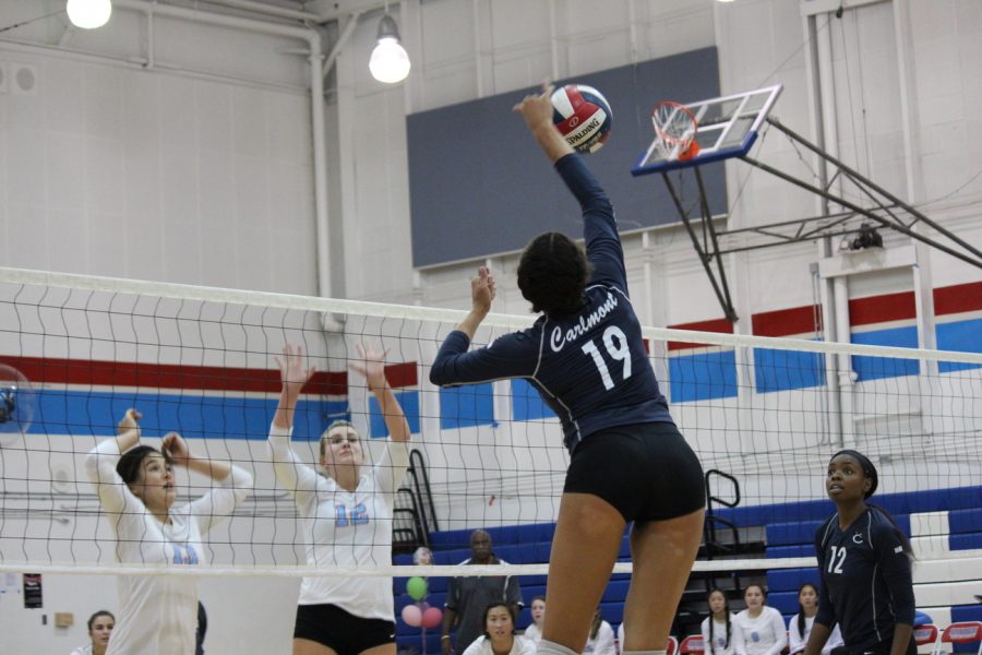 Junior Maya McCllean spikes the ball over the net earning  a point for the Scots. 