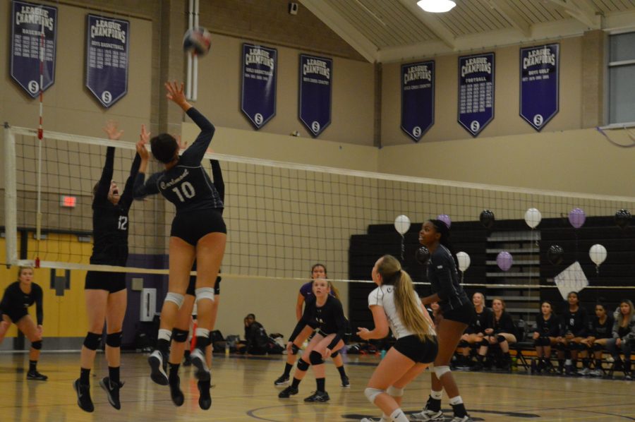 Junior Maya McClellan spikes the ball over the net earning points for the Scots. 