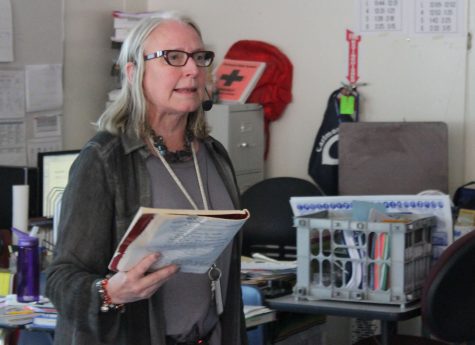 Foreign language teacher Roberta Scott speaks into a microphone when she teaches in order to project her voice over the sound produced by the construction outside of her classroom.