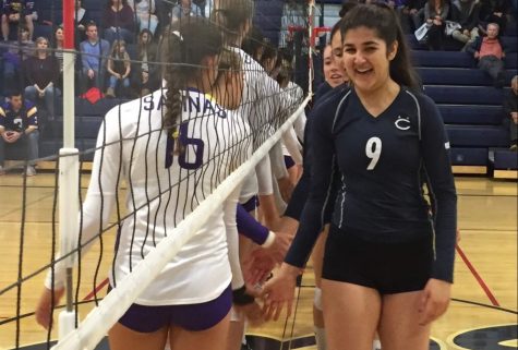 Senior Roz Soheili shakes hands with players from Salinas High School prior to the match.