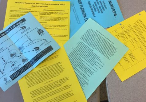 Informational handouts help students to learn about available classes as they prepare for the next school year.