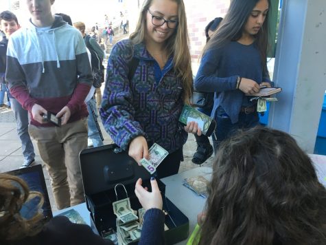 Eleventh-grader Kristina Dvorak buys a ticket for Winter Formal to spend a night with friends.