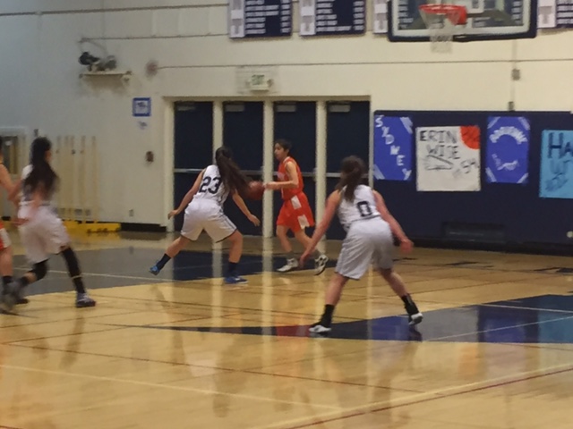 Carlmont puts up a tough defense against Woodside in their game. 