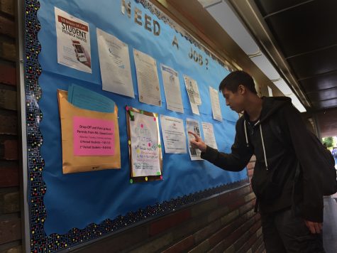 Ryan Kee, a sophomore, searches the job board for work and a place to make connections in the community.