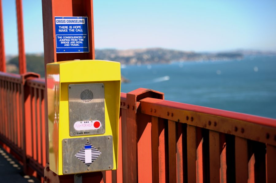 Sign and telephones hang along the Golden Gate Bridge to help stop those considering suicide from committing the act.