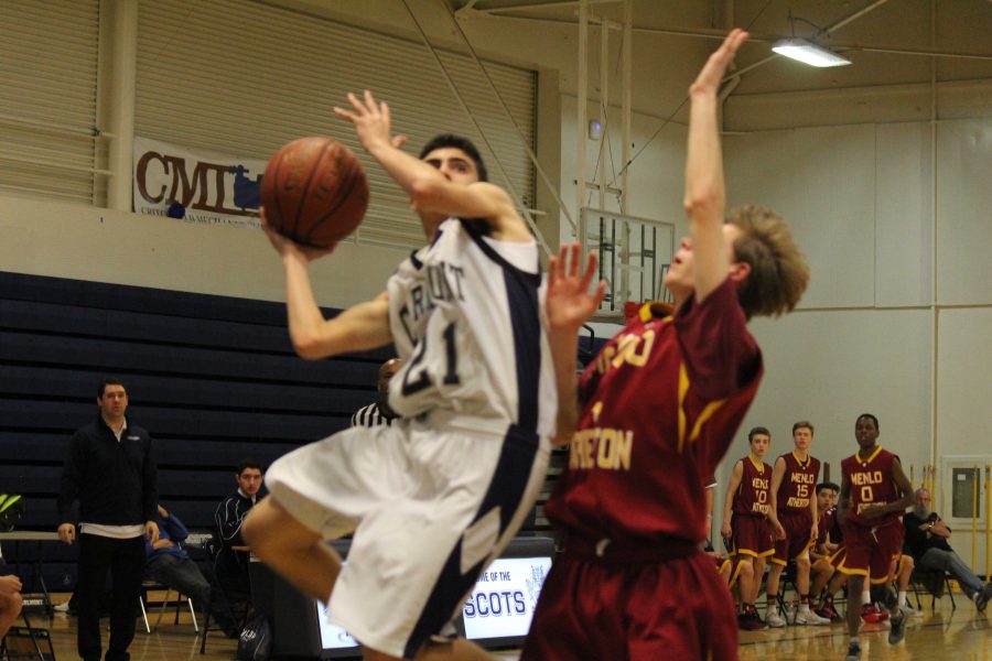 A+Carlmont+Scots++goes+up+for+a+layup+against+a+tough+Menlo-Atherton+defense.%0A