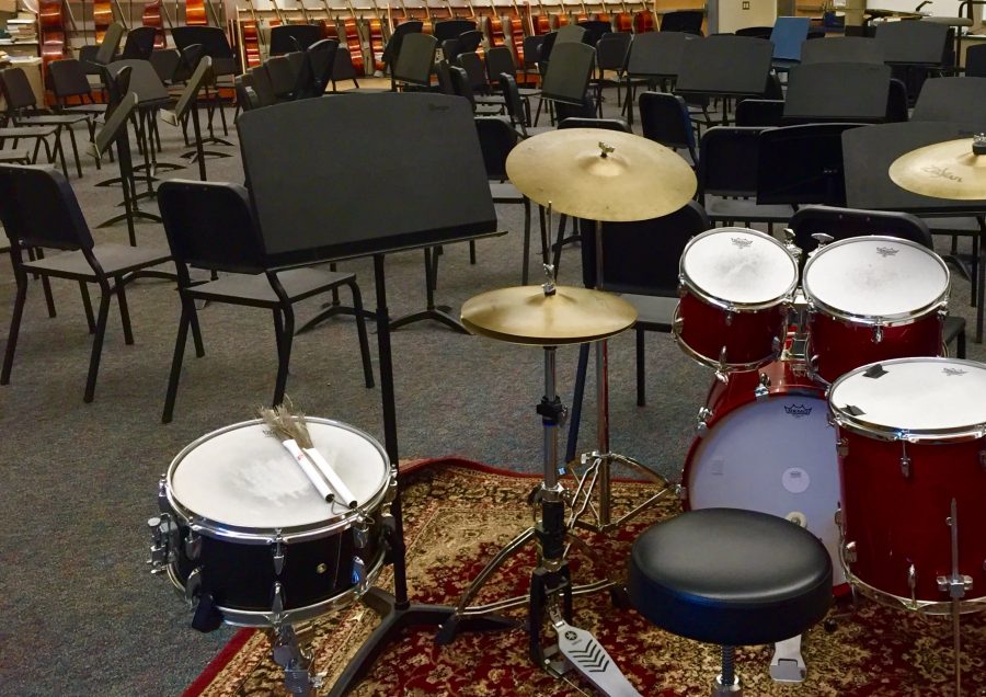 Drums and other instruments rest in the empty Carlmont band room where Concert Band practices.