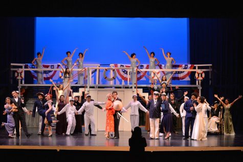 The cast members of Anything Goes pose onstage during the final scene as they receive applause.