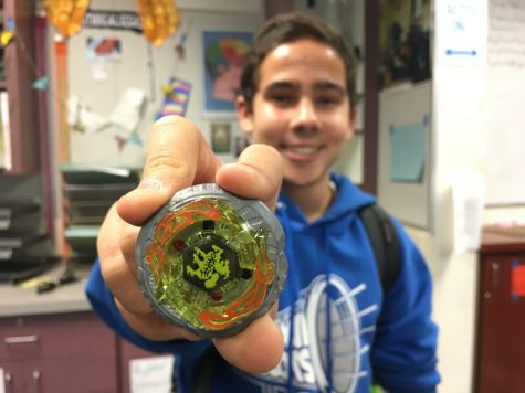 Sophomore Kyle Dimick presents the Beyblade that he hopes will bring him to victory in the upcoming tournament.