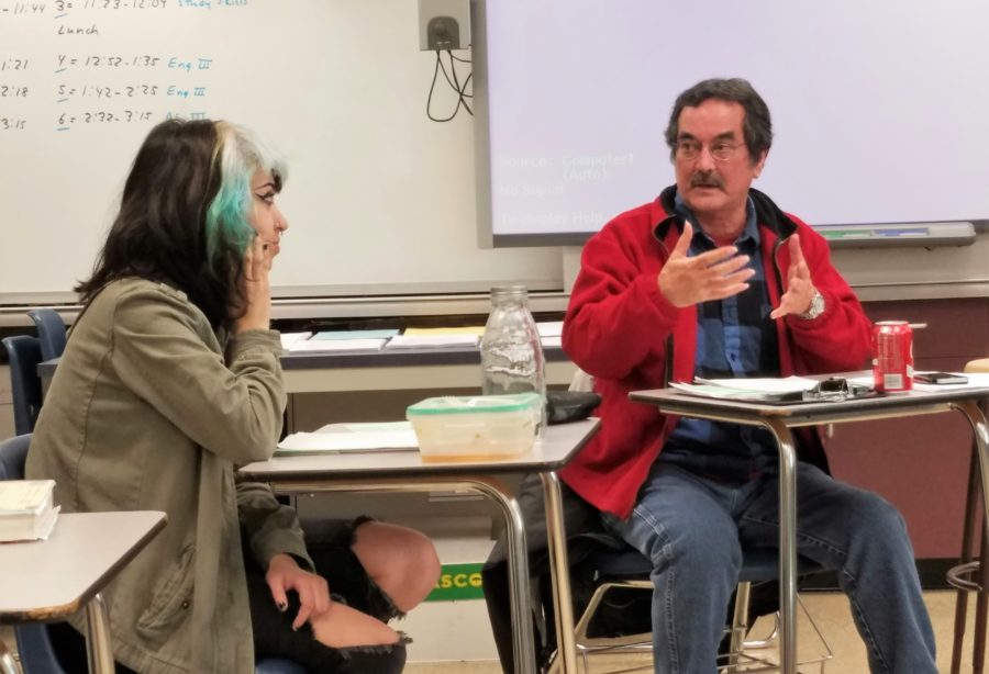 John Parker-Campbell, co-advisor, and Ashley Palacios, vice president, discuss To Wanglun, a poem by popular Chinese poet, Li Bai. Creative reWriters meets in room A16 on Fridays and sometimes Mondays.

