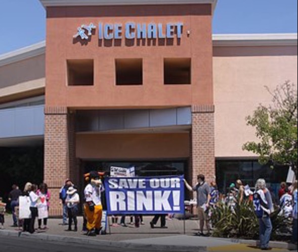 Protesters rally outside of the closed Ice Chalet, an ice skating rink in Bridgepointe Shopping Center.