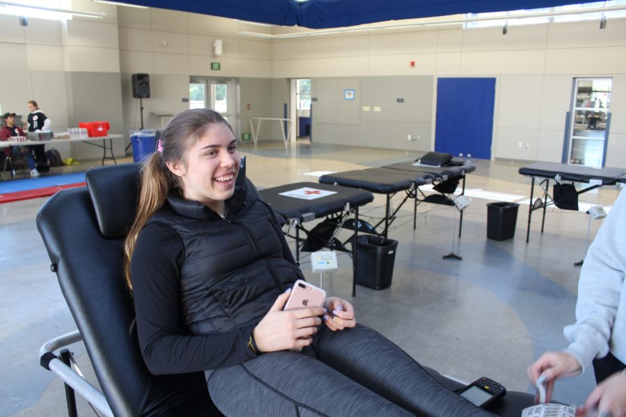 Sophomore Clara Vltavsky sits on a medical table as she prepares to give blood. 