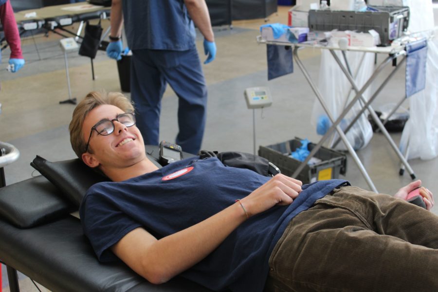 Liam Gunning, a junior, lies comfortably on a table as he gives blood. 