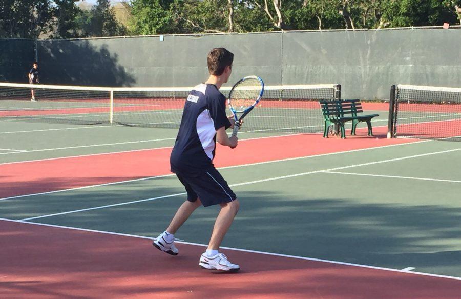 Doubles player Alexander Kessler, a junior, prepares to return his opponents serve.